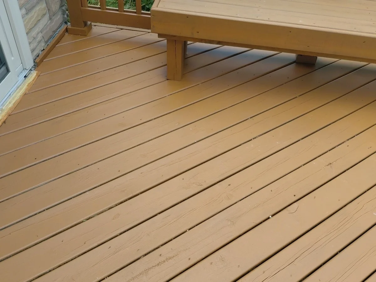 Newly finished wooden deck with horizontal planks and wooden railings