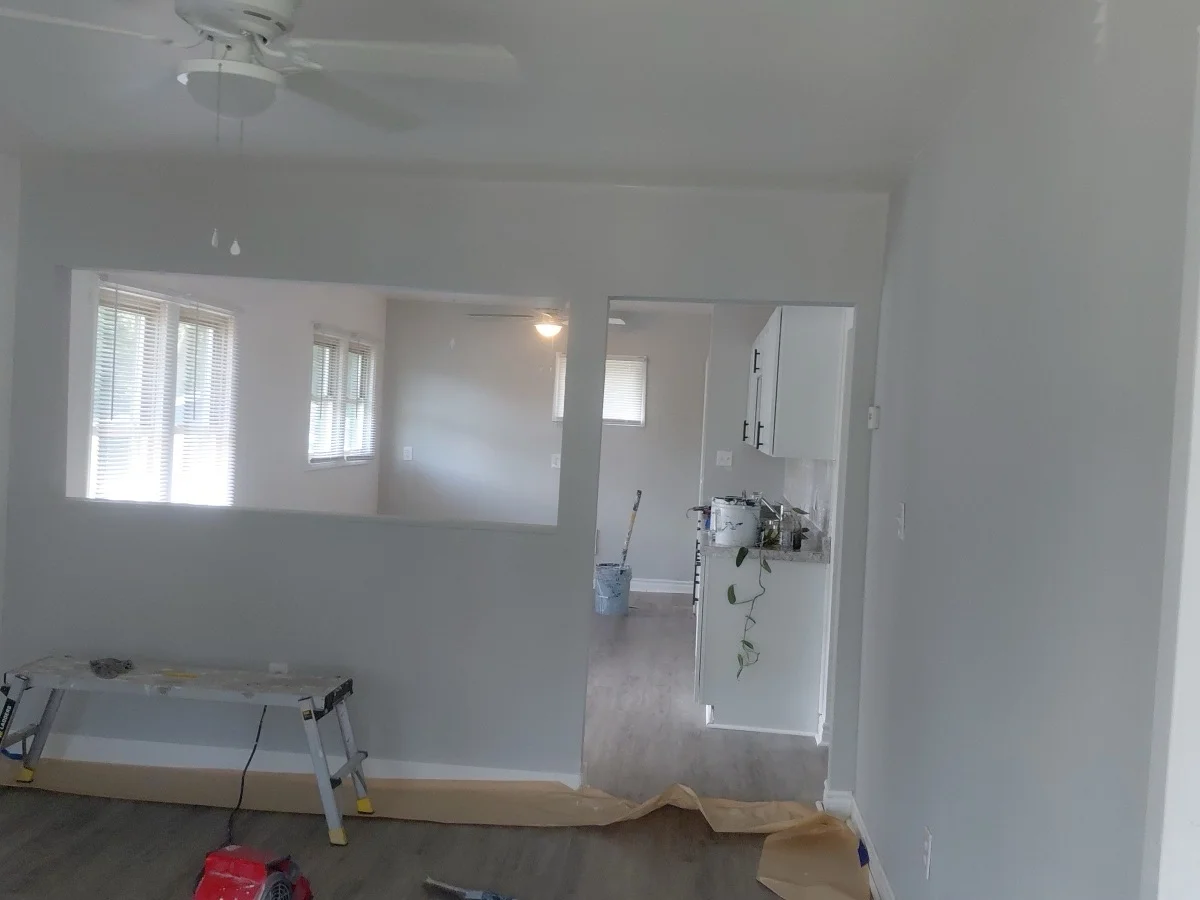 Bright, freshly painted interior with white walls and large windows letting in natural light
