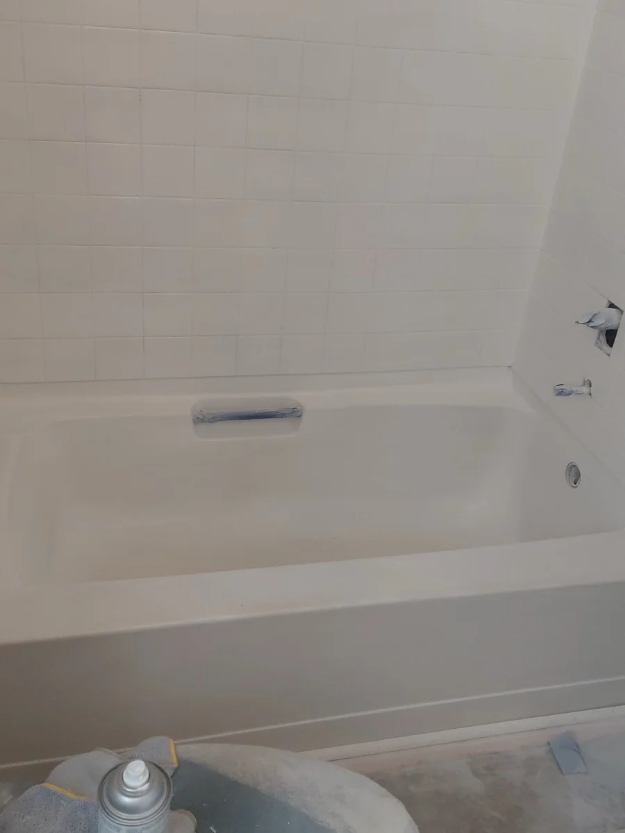Finished bathroom with white subway tile walls, a bathtub, and bright, even paint